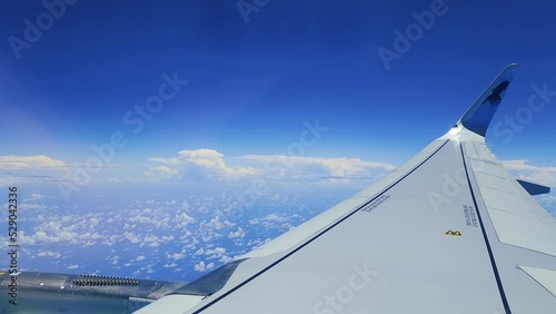 Shot of clouds and a blue sky from the airbus window photo