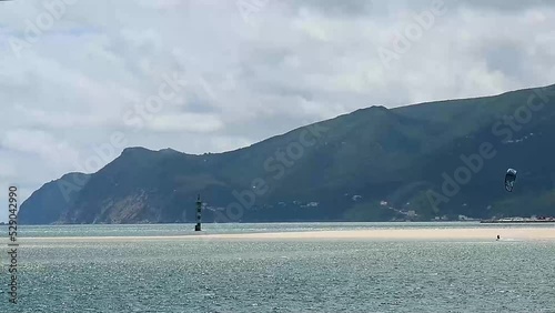 Man kitesurfing in the Atlantic ocean in Portugal