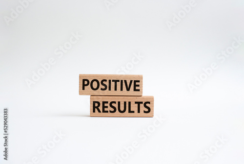 Positive results symbol. Concept words 'Positive results' on wooden blocks. Beautiful white background. Business and Positive results concept. Copy space.