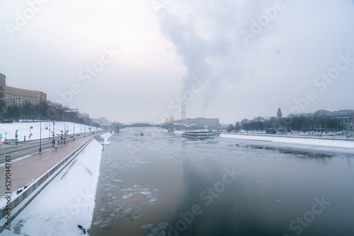 power station and ship in the river in city in winter © vasvormich