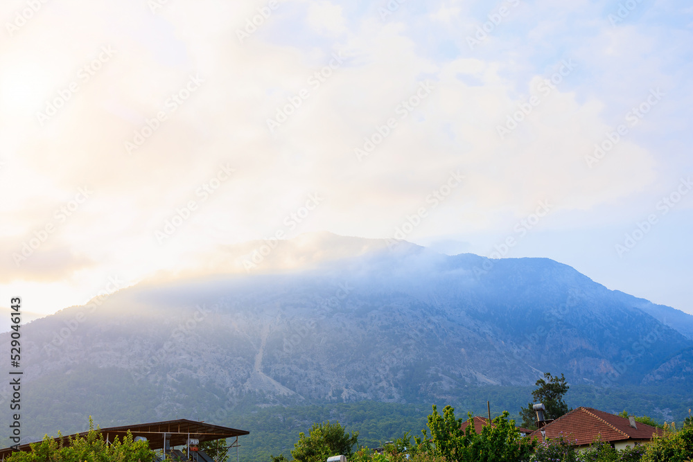 A very beautiful morning view of the mountain with haze at dawn with sun flare in Turkey. Background