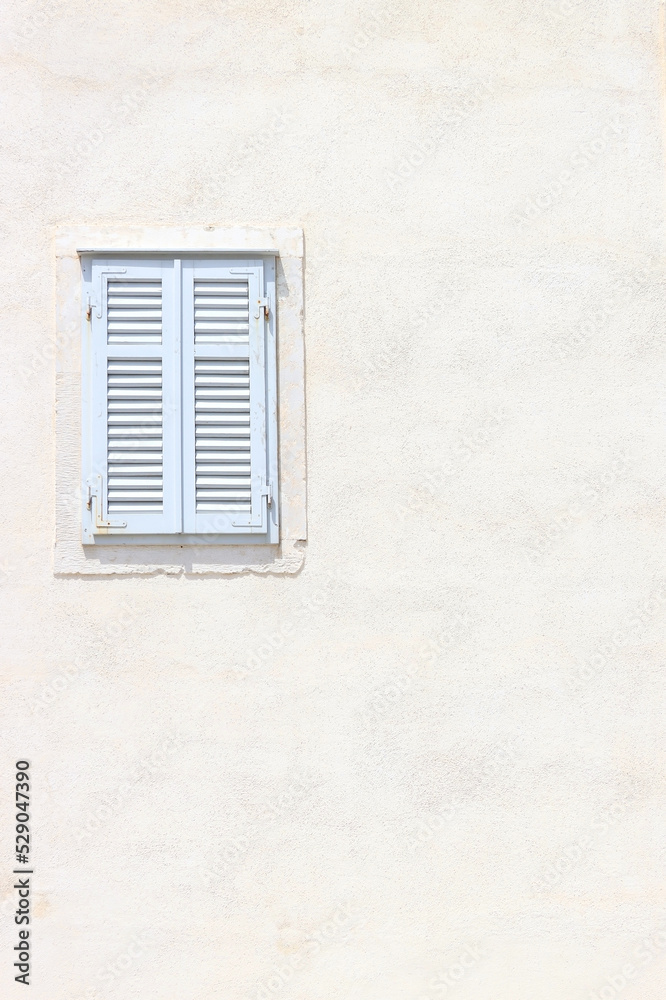Traditional Mediterranean window in white on white background.