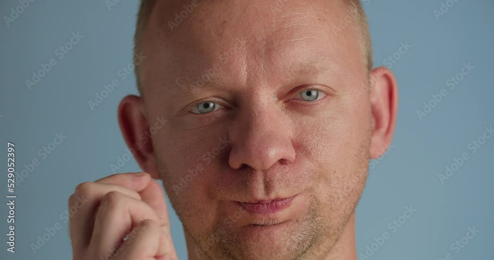 Man uses sign language zips mouth with hands asks to keep secret, close-up Man uses sign language zips mouth with hands asks to keep secret, close-up