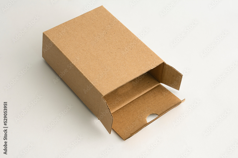 Small cardboard box on a white surface. Small cardboard box on a white surface.