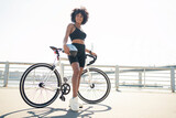 A woman rides a bicycle, exercising in fitness, in sportswear and helmet, eco-transport.