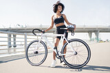 Cyclist woman cycling fitness training, road bike in the city.