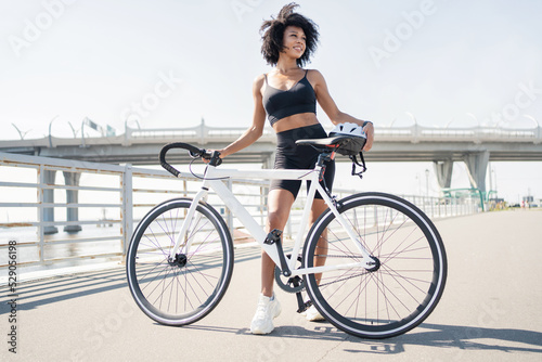 Fototapeta Naklejka Na Ścianę i Meble -  Cyclist woman cycling fitness training, road bike in the city.