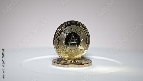 cardano coin rotating on white background photo
