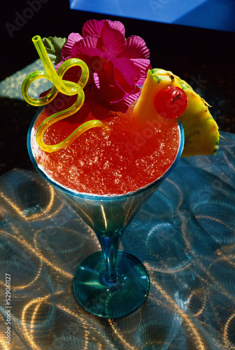 Daiquiri with decorative orchid and a pineapple wedge photo