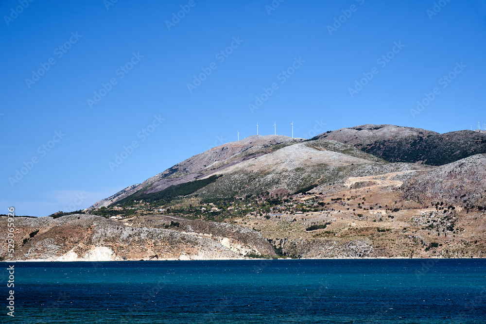 Wind turbines on a hill above the Ionian Sea on the island of Kefalonia