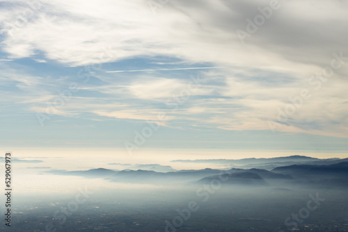 Sky with clouds over foggy plain