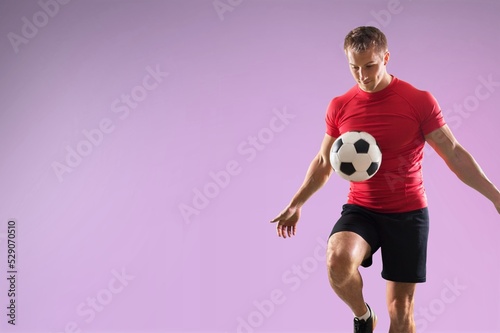 Young fun fan man cheer up support football sport team hold in hand soccer ball