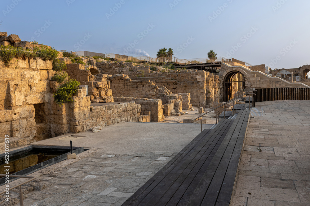 CAESAREA, Israel - August 2022, Roman emperor statue reflecting in a pool, Numerous tourists visit ruins fortress built by Herod the Great near Caesarea city, on the shores of the Mediterranean Sea