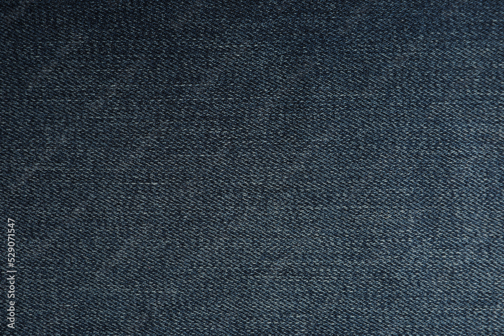 Texture of dark blue jeans as background, closeup