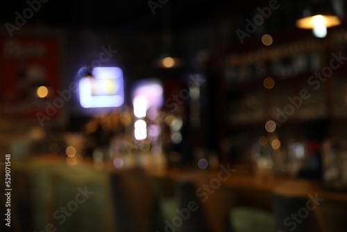 Blurred view of stylish modern bar interior with bokeh effect