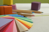 Color palette on white wooden table, closeup