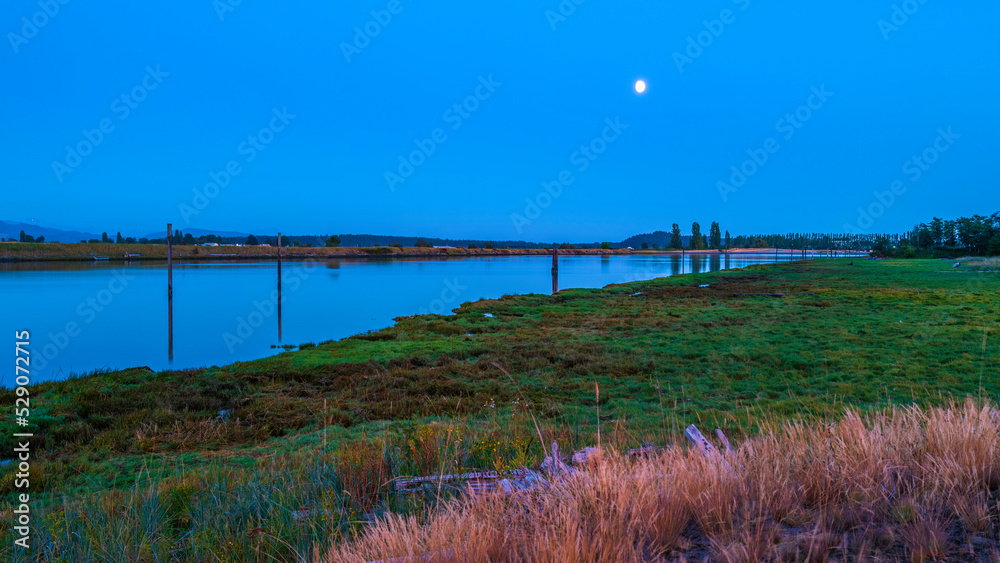 Moonrise night landscape over Swinomish Channel marshland near Skagit Bay in La Conner, Washington State