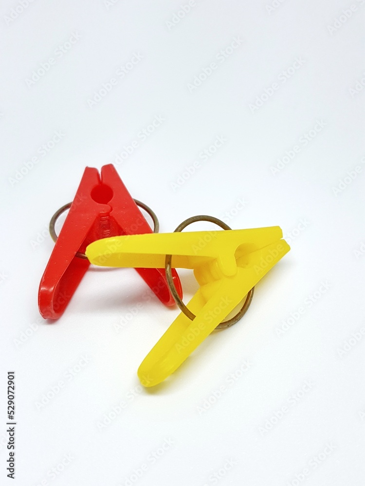 Isolated photo of clothespins in red and yellow with very contrasting colors. Isolated photo of clothespins in red and yellow with very contrasting colors.