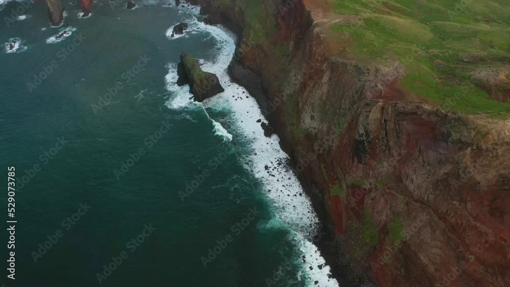 Tilt up drone shot over a cliff of a peninsula in Madeira during sunset. Tilt up drone shot over a cliff of a peninsula in Madeira during sunset.