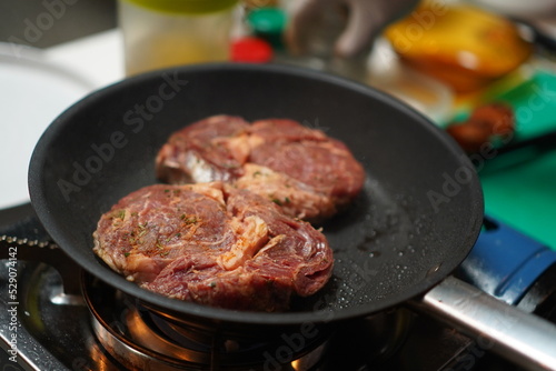 Cooking delicious beef steak in frying pan