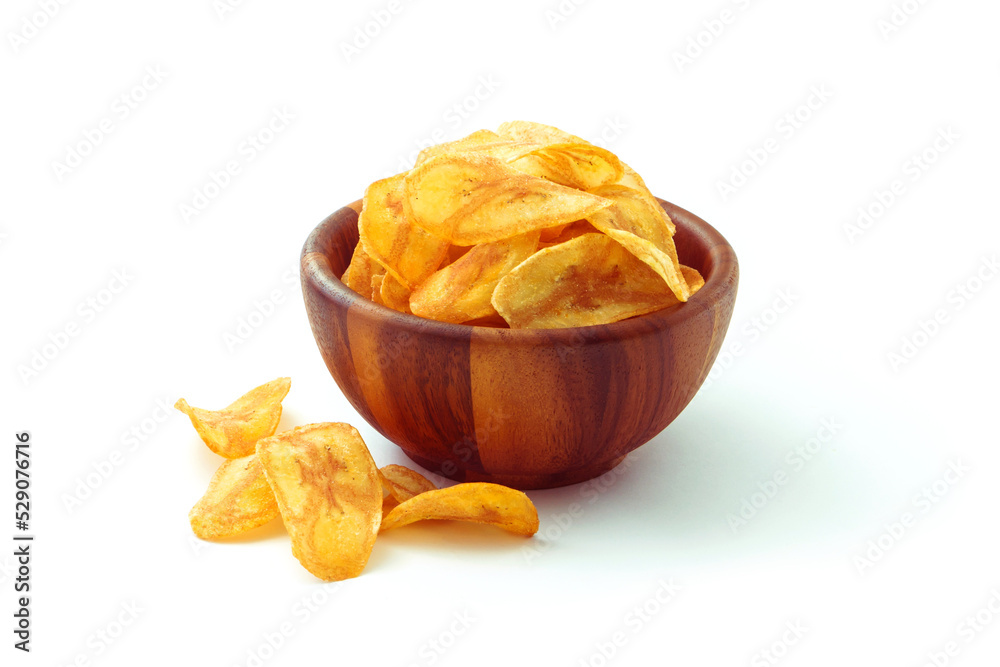 Banana slice chips in wooden bowl isolated on white background. Banana slice chips in wooden bowl isolated on white background.