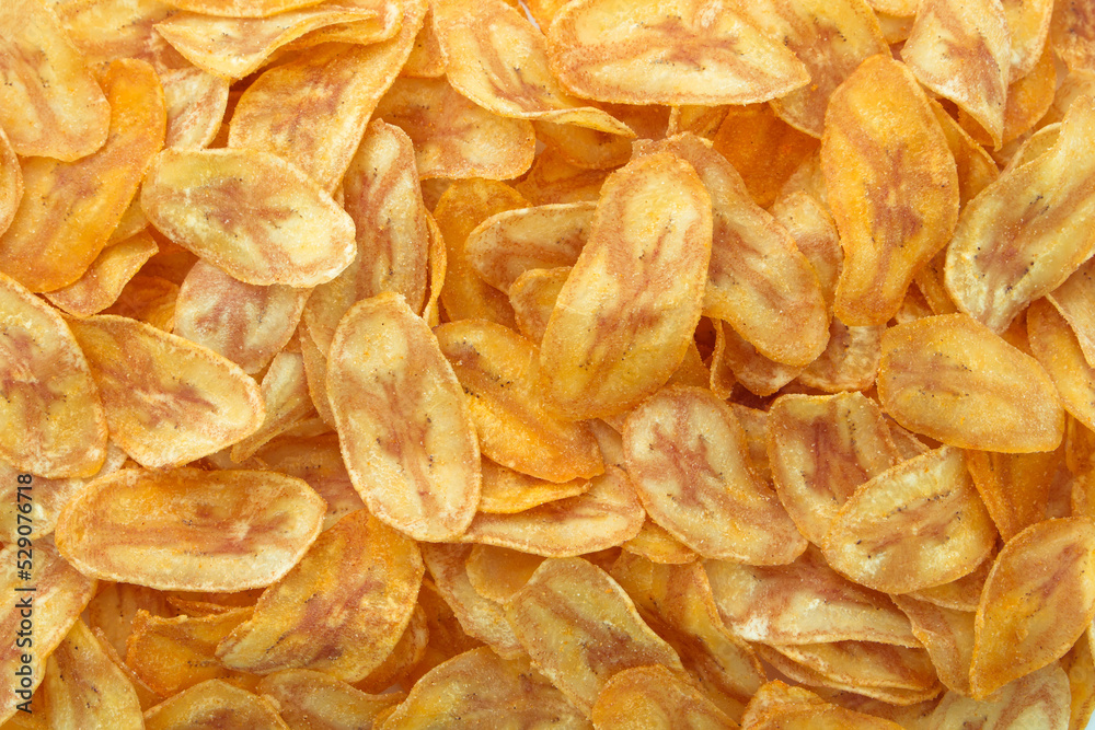 Pile banana slice chips texture background , top view , flat lay.