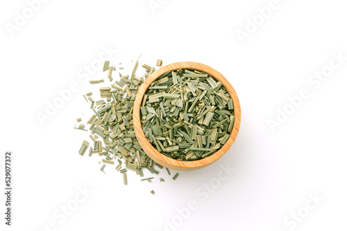 Dry lemongrass leaves slices in wooden bowl isolated on white background , top view , flat lay.