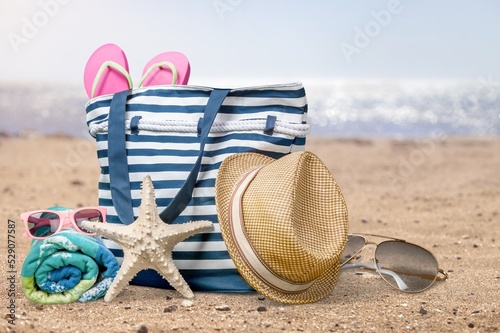 Straw hat and sunglasses on the beach. Beach holiday concept background.