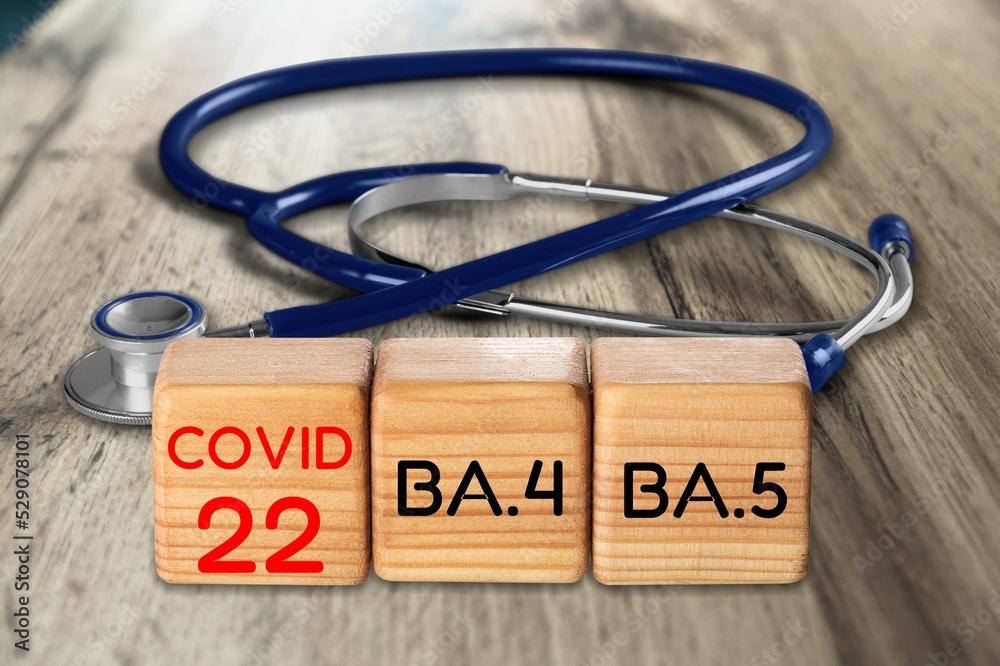 Wooden blocks on the desk. Scientific symbols of the coronavirus evolved from the omicron. The concept of the spread of new mutations of the virus in 2022 Wooden blocks on the desk. Scientific symbols of the coronavirus evolved from the omicron. The concept of the spread of new mutations of the virus in 2022