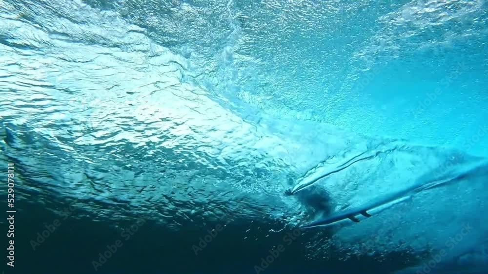 Surfer surfing big tube barrel wave. crystal clear Tahiti ocean on a sunny day. Teahupoo famous destination in French Polynesia. Adventure water sports travel. slow motion.