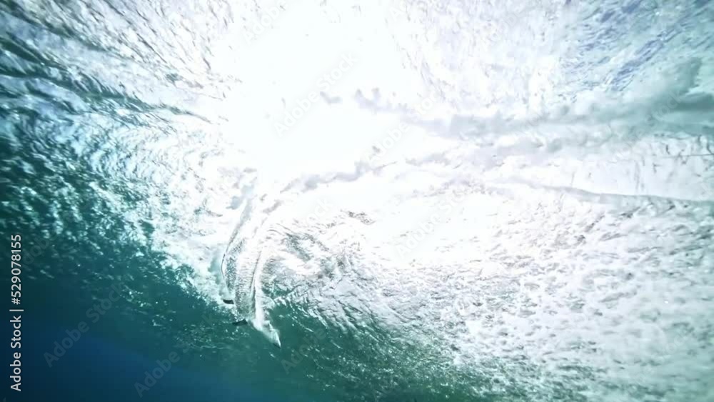 Underwater Tahiti. Glassy ocean tube wave crashing, perfect barrel for surfing. Teahupoo famous surfing action sports destination in French Polynesia. slow motion. 