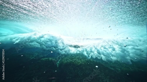 Underwater shot of blue wave barrel forming and breaking. Teahupoo famous surfing action sports destination in Tahiti. surf destination travel in French Polynesia. slow motion. 