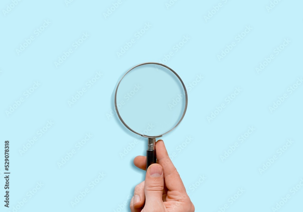 Male hand holds a magnifier focusing. To focus on the current situation, positive thinking mindset concept. Male hand holds a magnifier focusing. To focus on the current situation, positive thinking mindset concept.