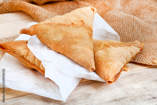 South African chicken Samosas on rustic table