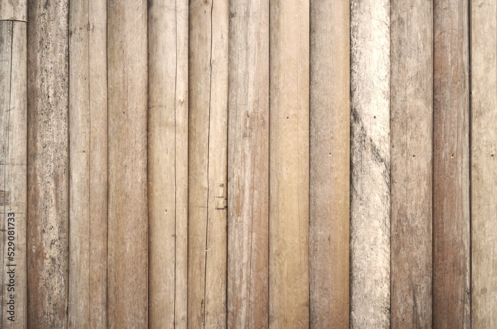Natural white beige log wall texture background. Fence lined with old logs. Natural white beige log wall texture background. Fence lined with old logs.