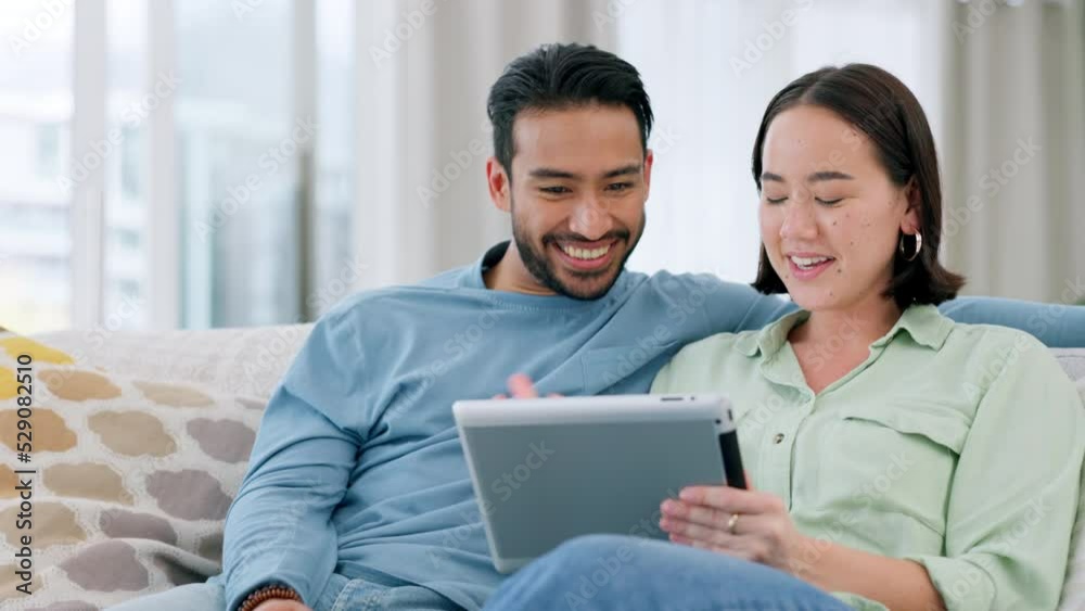 Couple streaming funny meme video on tablet online, watching comedy movie on technology and relax with internet connection for social media. Comic, talking and Asian man and woman on web on the sofa Couple streaming funny meme video on tablet online, watching comedy movie on technology and relax with internet connection for social media. Comic, talking and Asian man and woman on web on the sofa