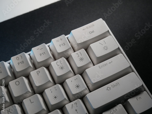 white keyboard 60% layout on a black deskmat photo
