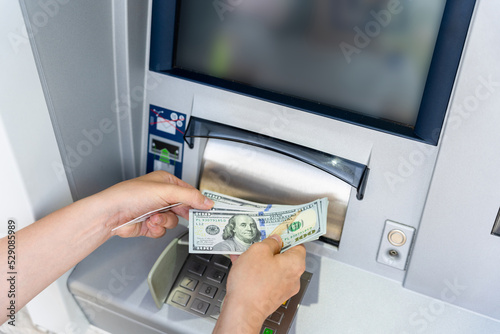 Atm card machine cash. Holding american bill cash. Woman withdraw money usd hundred dollar. Bank credit card money background.