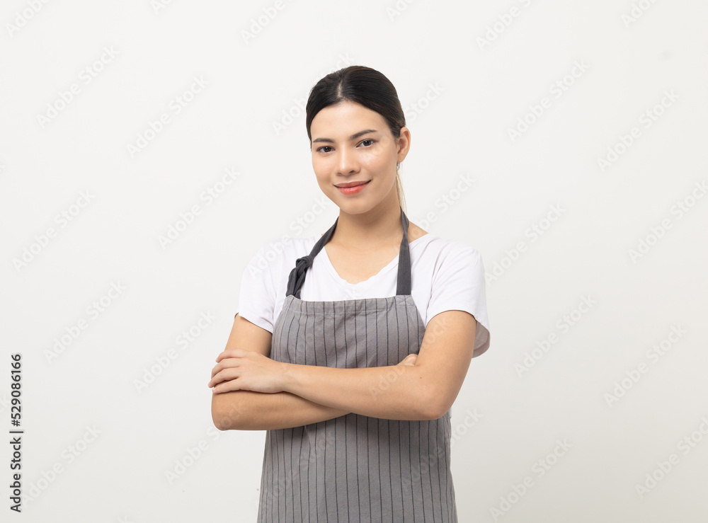 Young beautiful woman with apron standing on isolated white background. Housekeeping housework or maid worker concept. Young beautiful woman with apron standing on isolated white background. Housekeeping housework or maid worker concept.