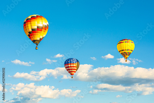 Colorful air balloon in the cloudy sunset sky
