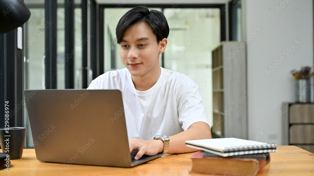 Talented Asian businessman working on his project assignment, using laptop. Talented Asian businessman working on his project assignment, using laptop.