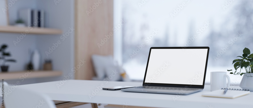 Notebook laptop mockup and stuff on white tabletop over blurred modern home living room background - obrazy, fototapety, plakaty 