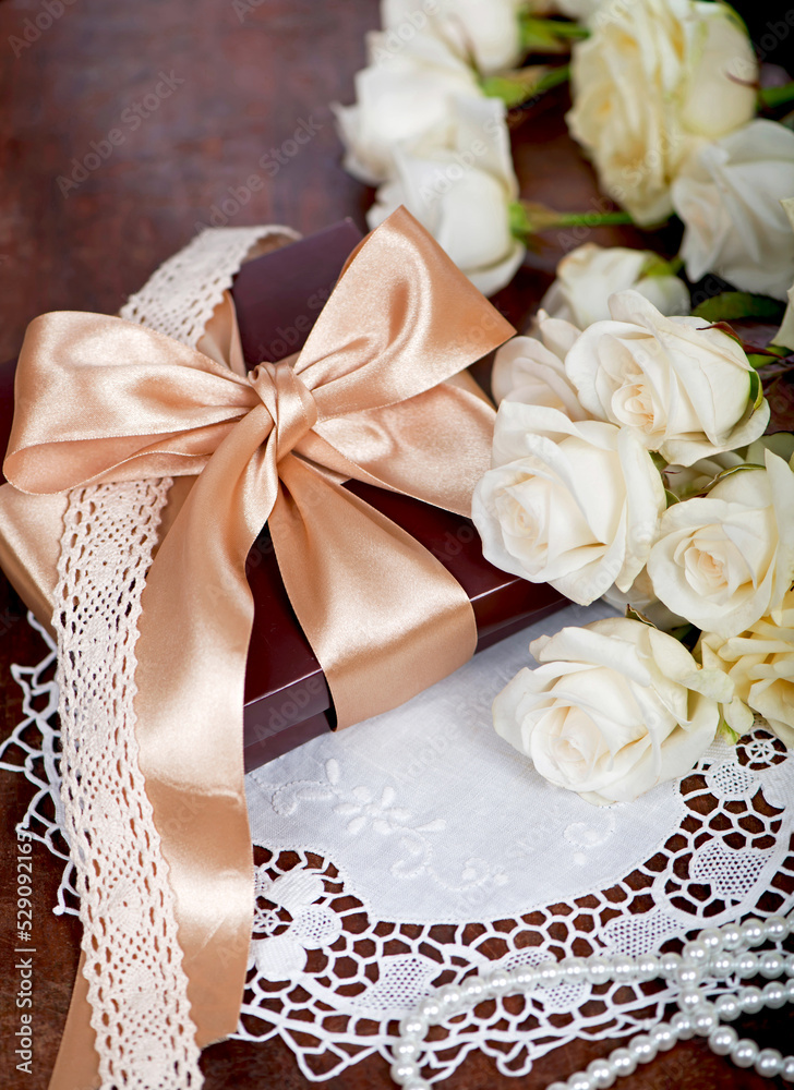 empty card form and bouquet of white rose with green leaves on a wooden empty card form and bouquet of white rose with green leaves on a wooden