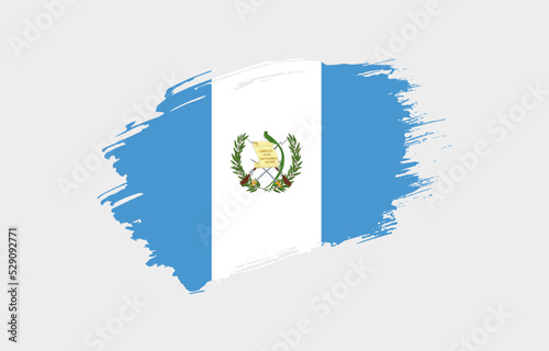 Creative hand drawn grunge brushed flag of Guatemala with solid background photo
