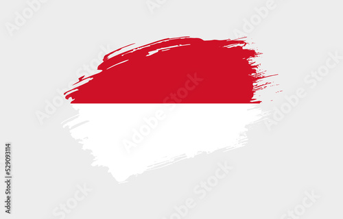 Creative hand drawn grunge brushed flag of Monaco with solid background