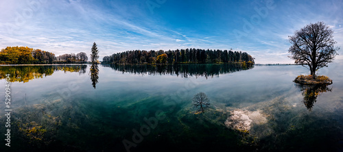 Beautiful lake with blue sky and clean water with tree reflections. 3D illustration