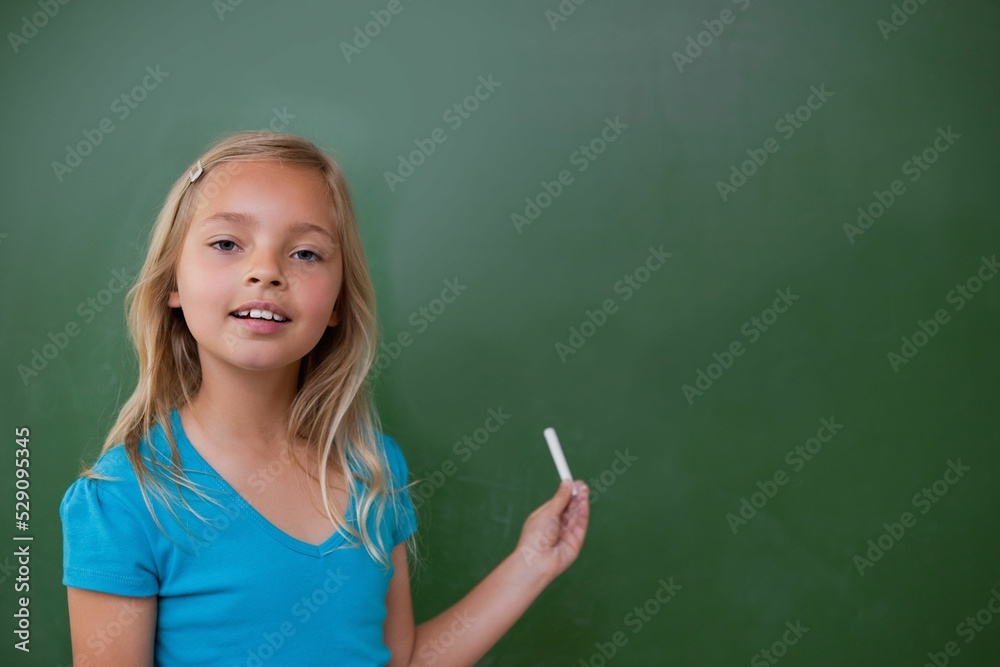 Cute pupil holding chalk