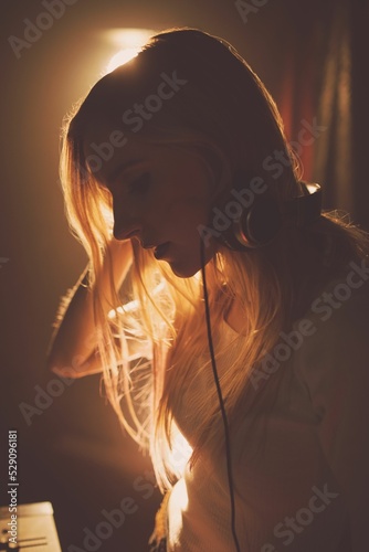 Side view of young woman in music studio