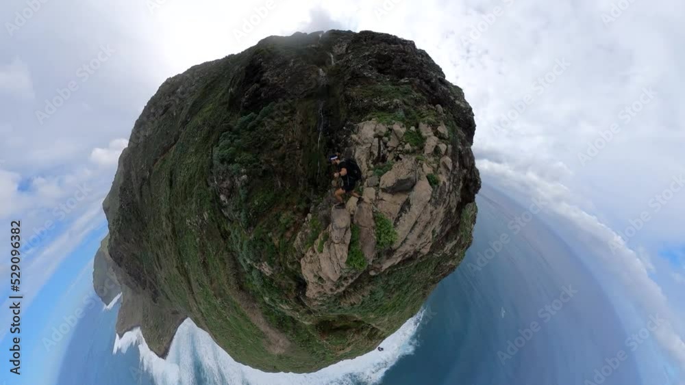 Selfie shot of a man reaching the very edge of Quebrada do Negro in Madeira. Careful steps onto the rock at the steep edge. Selfie shot of a man reaching the very edge of Quebrada do Negro in Madeira. Careful steps onto the rock at the steep edge.