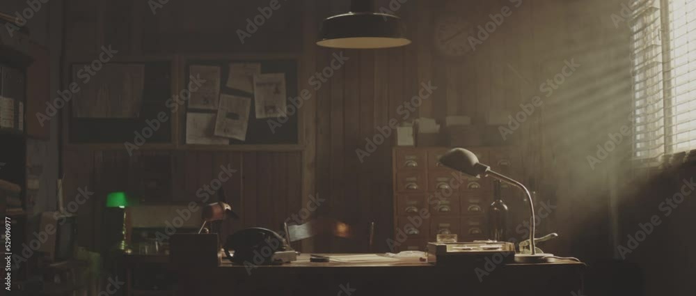 Empty vintage retro style office lighted by dimmed desk lamp. 